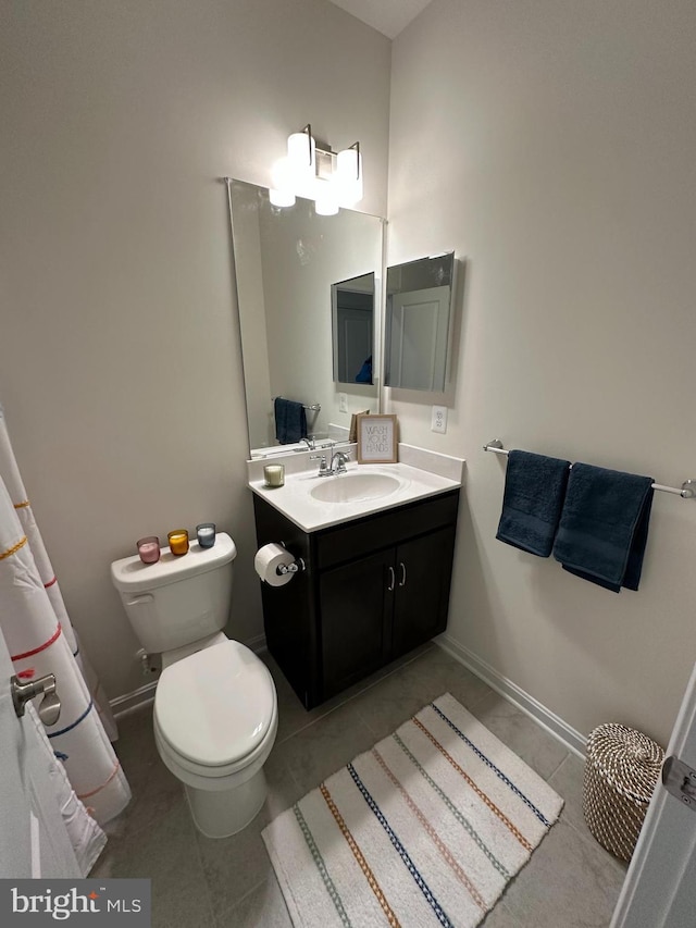 bathroom with vanity, toilet, and tile patterned flooring