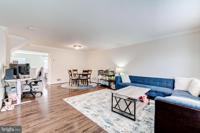 living room featuring hardwood / wood-style flooring and ornamental molding