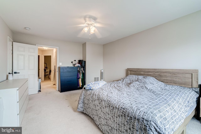 bedroom with light carpet and ceiling fan