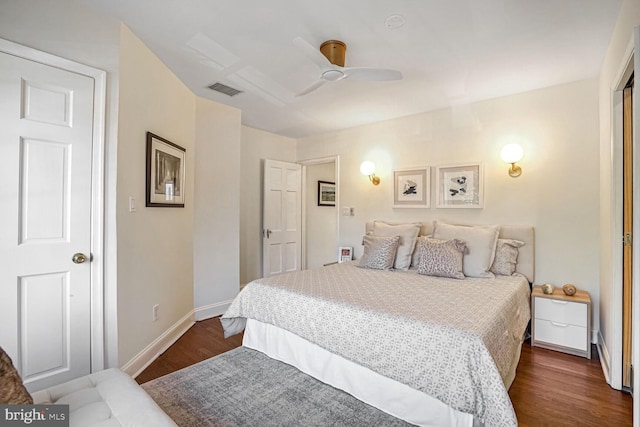 bedroom with dark hardwood / wood-style flooring and ceiling fan