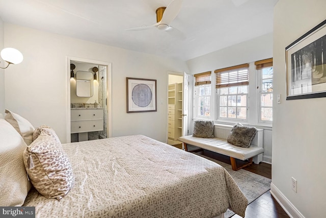 bedroom with ceiling fan, ensuite bath, and wood-type flooring