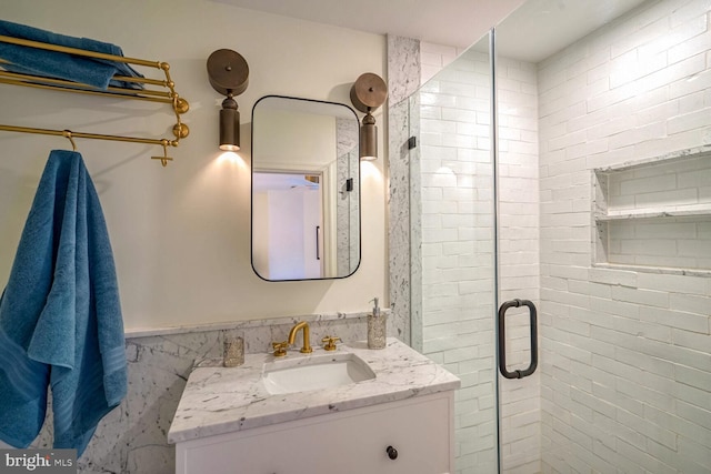 bathroom featuring an enclosed shower and vanity