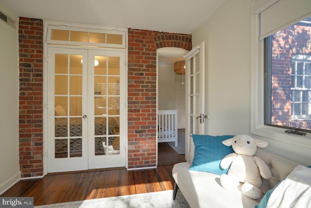 sunroom / solarium with a healthy amount of sunlight and french doors