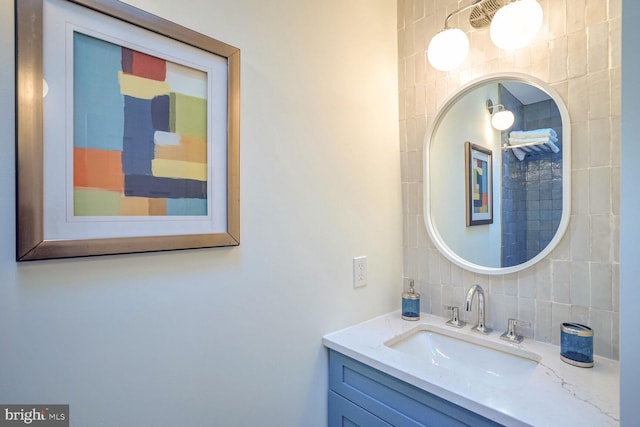 bathroom featuring tasteful backsplash, vanity, and tile walls