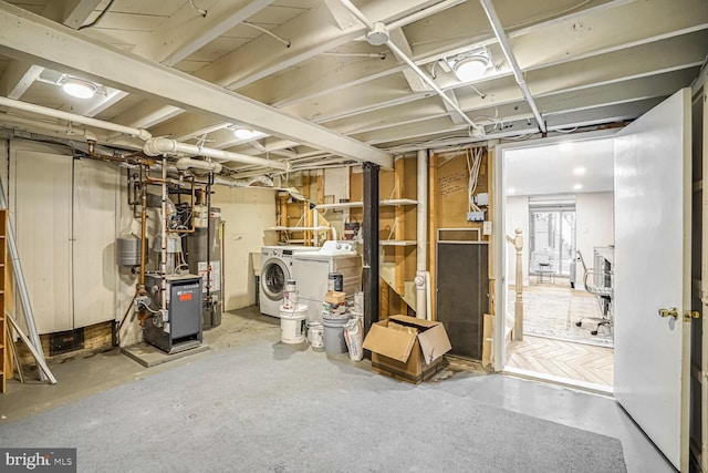 basement featuring washing machine and dryer and gas water heater