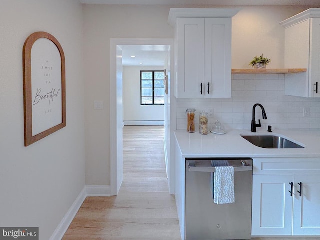 kitchen featuring a baseboard heating unit, dishwasher, sink, and white cabinets