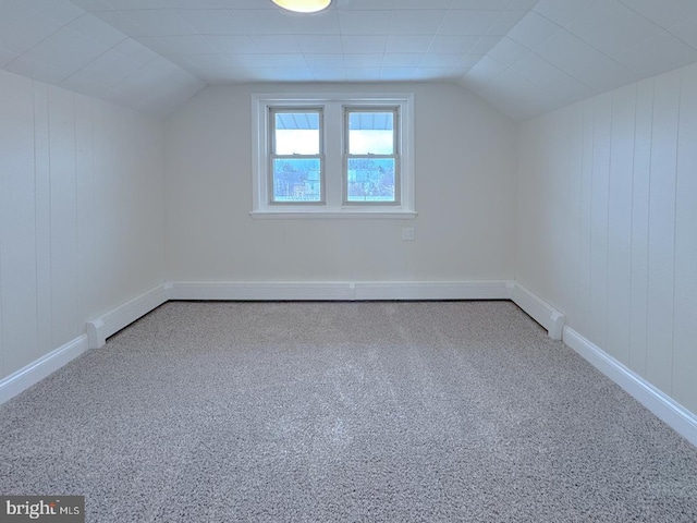 bonus room with vaulted ceiling and carpet