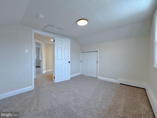 additional living space with lofted ceiling, carpet floors, and a baseboard radiator