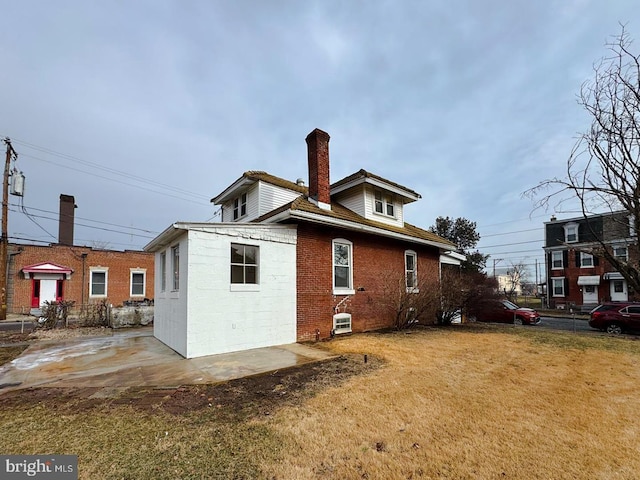 rear view of property featuring a lawn