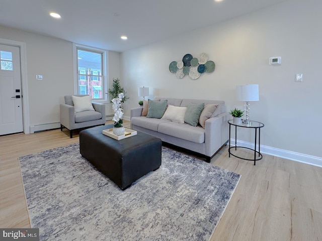 living room with light hardwood / wood-style flooring and baseboard heating