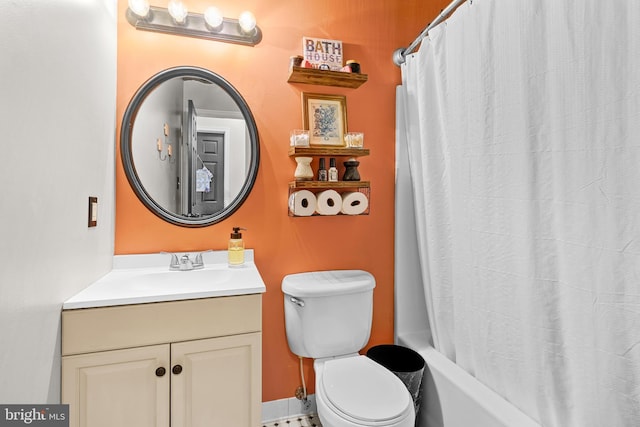 full bathroom with vanity, shower / bath combo with shower curtain, and toilet