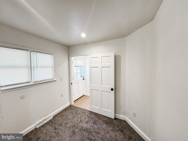 unfurnished bedroom featuring light carpet