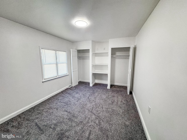 unfurnished bedroom with dark colored carpet