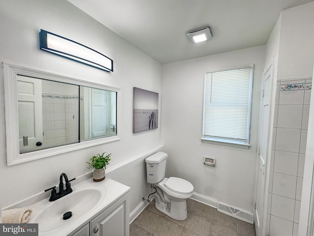 bathroom featuring vanity, tile patterned flooring, and toilet