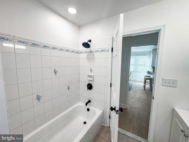 bathroom with tile patterned flooring and tiled shower / bath