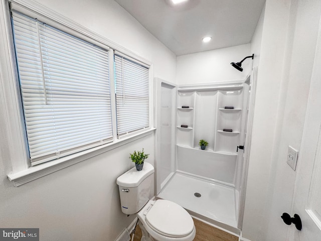 bathroom featuring toilet and walk in shower