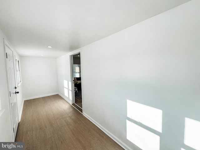 hallway with dark hardwood / wood-style flooring