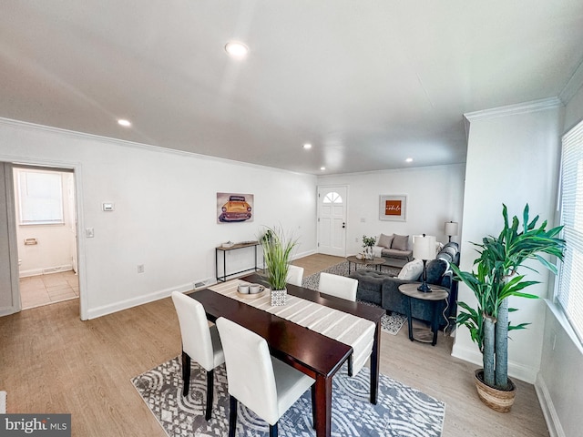 dining room featuring crown molding and light hardwood / wood-style floors