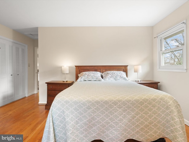 bedroom featuring wood-type flooring and a closet