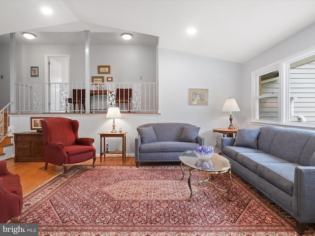 living room with vaulted ceiling and hardwood / wood-style floors