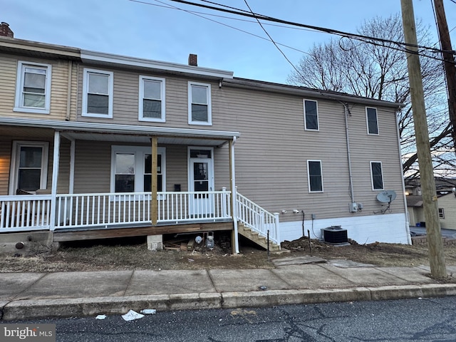 view of front of house with a porch and central air condition unit