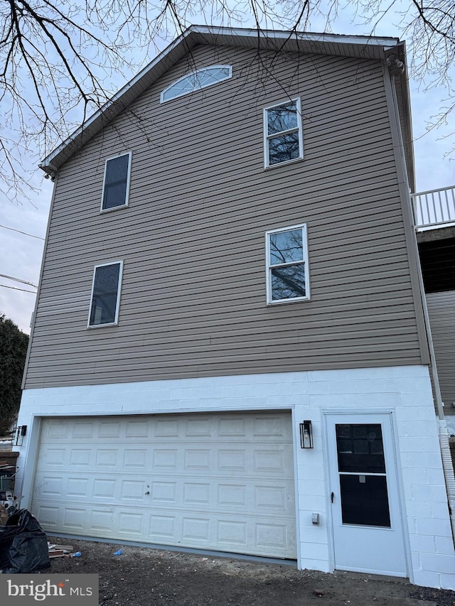 view of side of property with a garage