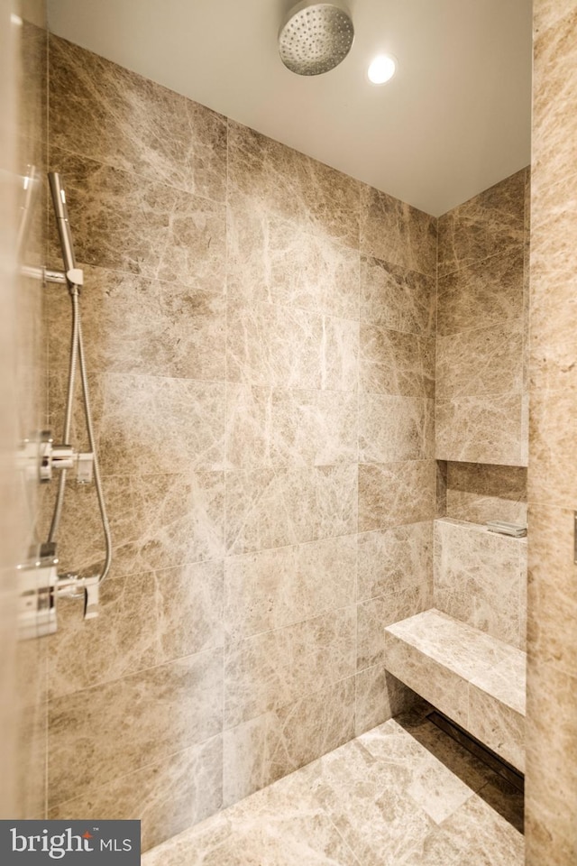 bathroom with a tile shower