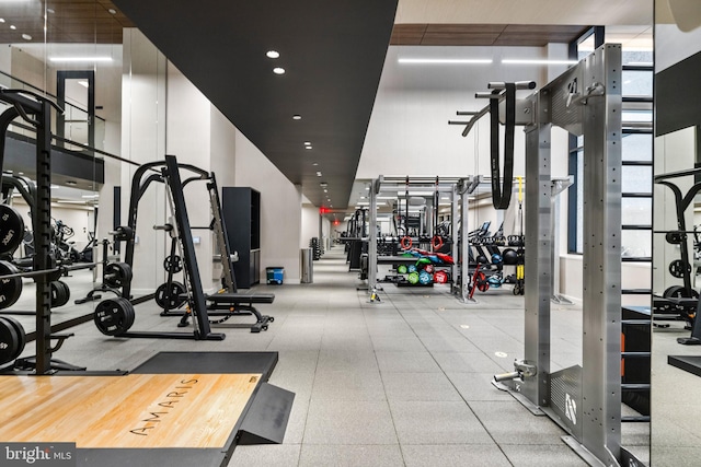 exercise room with a high ceiling