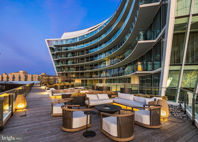 deck at dusk featuring an outdoor living space