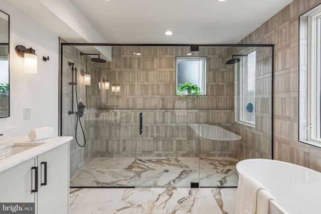 bathroom with vanity and separate shower and tub