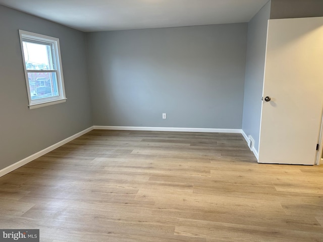 empty room with light hardwood / wood-style floors