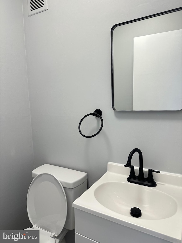 bathroom with vanity and toilet