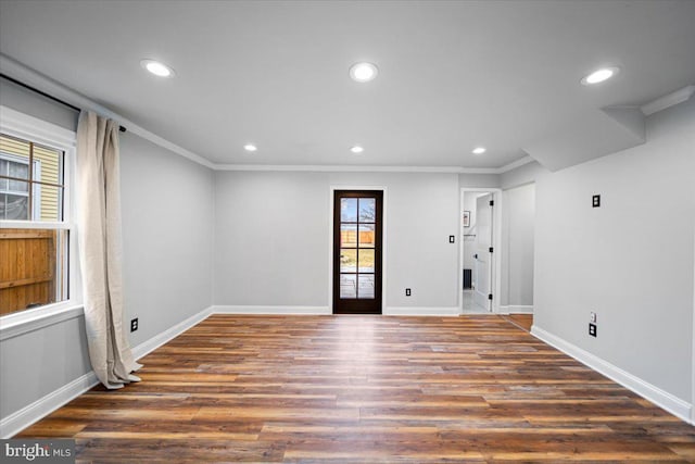 unfurnished room with crown molding and dark hardwood / wood-style flooring