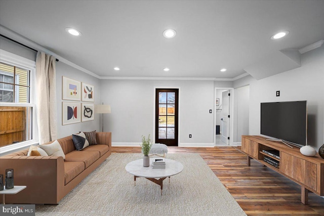 living room with crown molding and hardwood / wood-style flooring