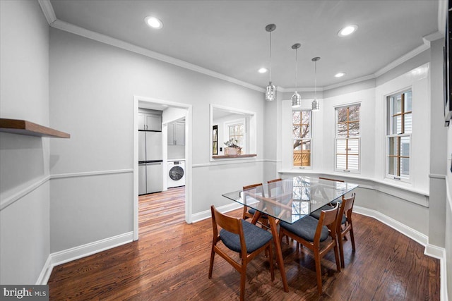 dining area featuring washer / clothes dryer, ornamental molding, and dark hardwood / wood-style floors