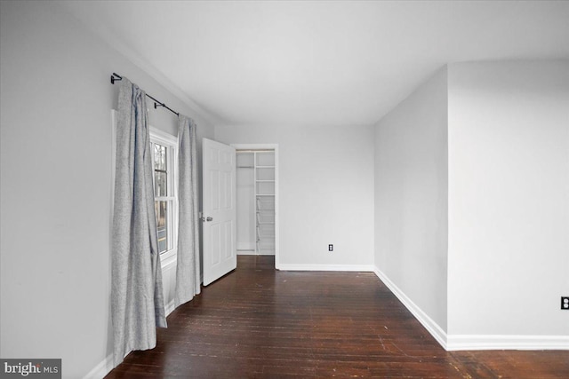 corridor featuring dark hardwood / wood-style floors