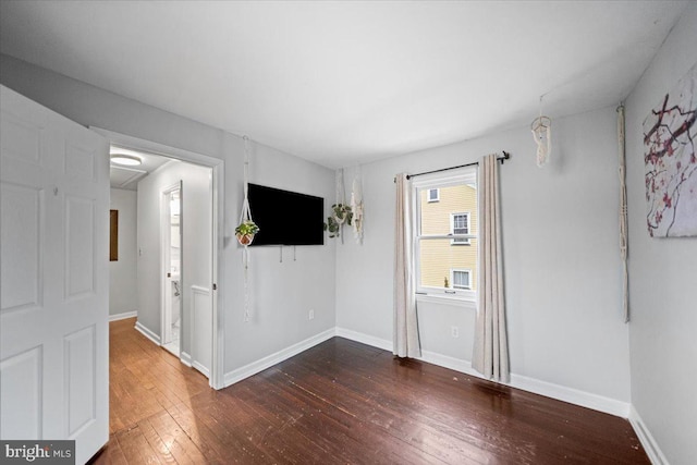 empty room featuring dark hardwood / wood-style flooring