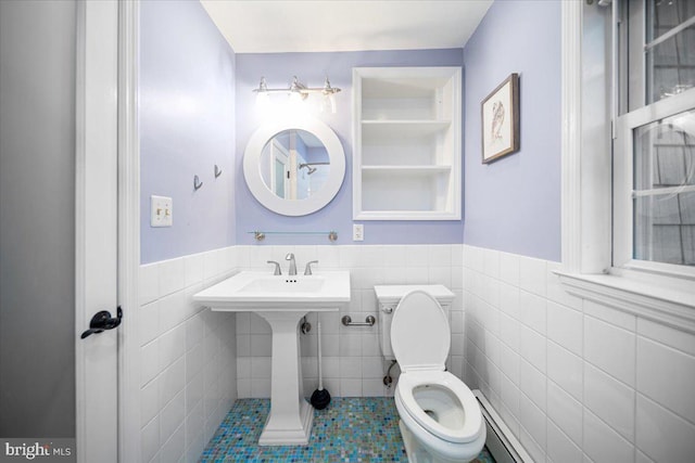 bathroom featuring tile walls and toilet