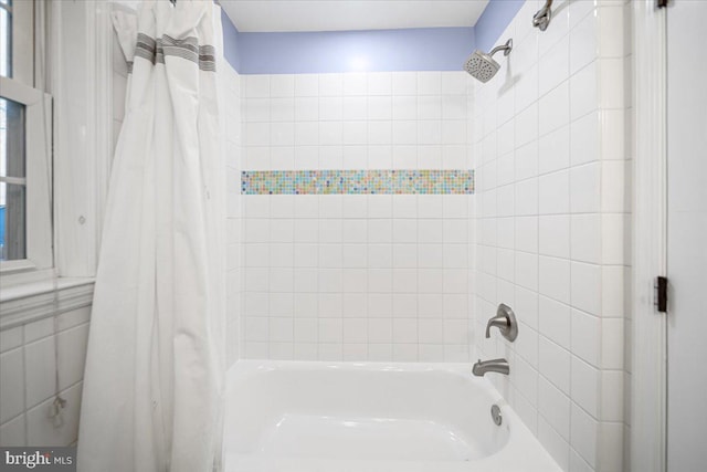 bathroom with shower / bathtub combination with curtain