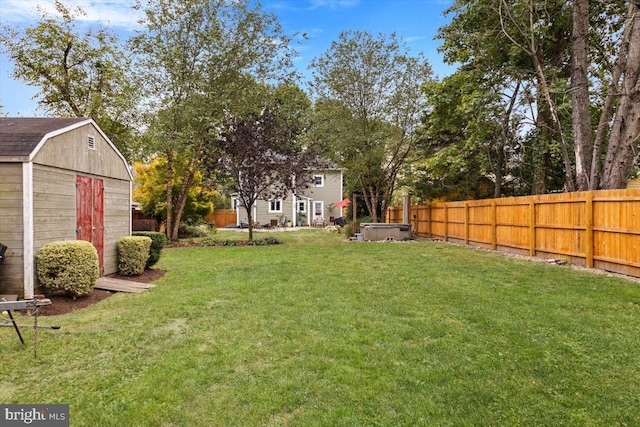 view of yard with a hot tub and a storage unit