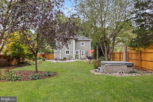 view of yard with a patio area and a hot tub