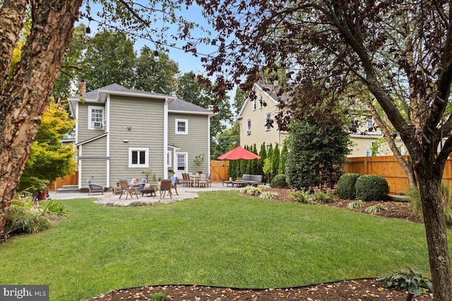 rear view of property with a lawn and a patio