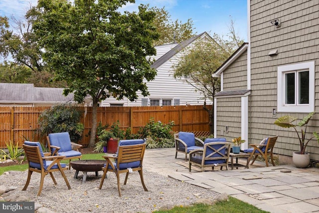 view of patio featuring an outdoor living space with a fire pit