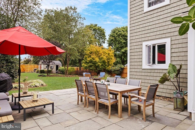 view of patio / terrace with a storage shed