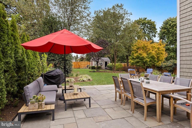 view of patio featuring area for grilling and a storage shed