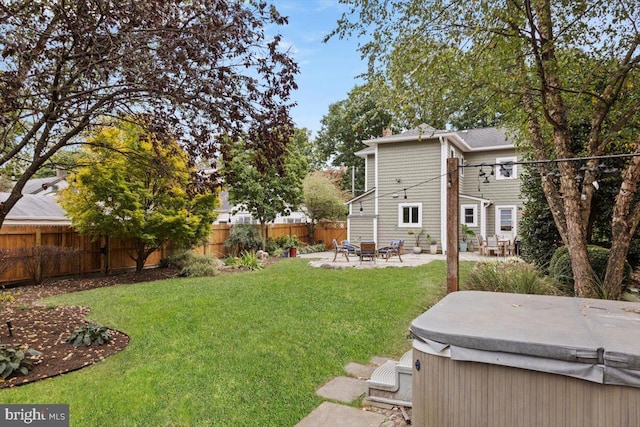 view of yard featuring a hot tub and a patio