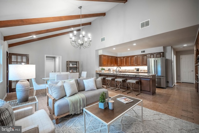 living room with high vaulted ceiling, beam ceiling, a chandelier, and sink