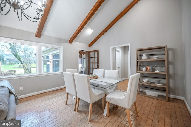 dining space with beam ceiling, high vaulted ceiling, and a chandelier