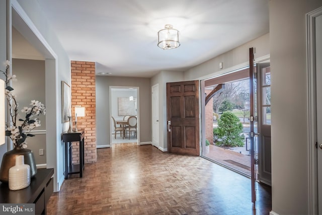 foyer with dark parquet floors