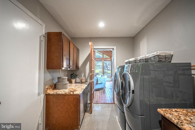 washroom featuring cabinets and independent washer and dryer